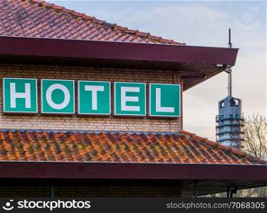 Hotel sign on the rooftop of a hotel, city scenery and architecture, travel concept