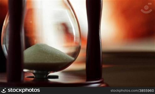 hourglass and book on background of the fireplace.