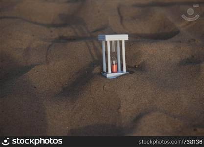 Hourglass on a sand dune beach.. Hourglass on a sand dune beach