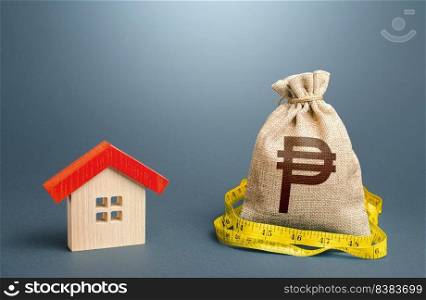 House and a philippine peso money bag. Property real estate valuation. Building maintenance. Mortgage loan. Calculation of expenses for purchase, construction, repair. Buying and selling, fair price.