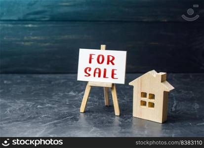 House and sign for sale. Buying and selling housing. Search for options. Property appraisal. Secondary realty market. Attractive prices. Investing in a rental business. Affordable housing.