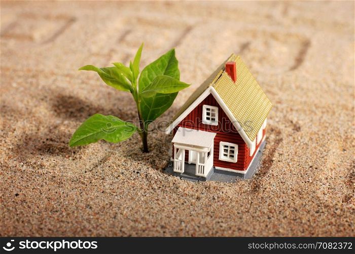 House and tree over sand background.