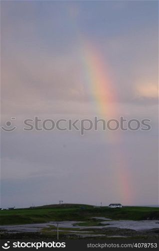 House beneath rainbow
