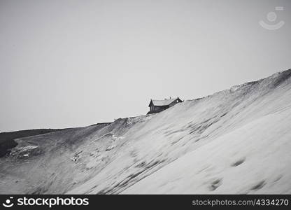 House built on snowy hilltop