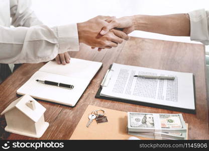 House developers agent or financial advisor and customers shaking hands after signing document making deal as successful agreement, contract with a firm