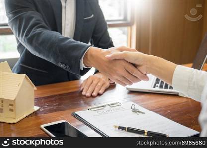 House developers agent or financial advisor and customers shaking hands after signing document making deal as successful agreement, contract with a firm