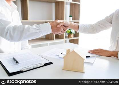 House developers and customer shaking hand after finish buying or rental real estate for transfer right of property.