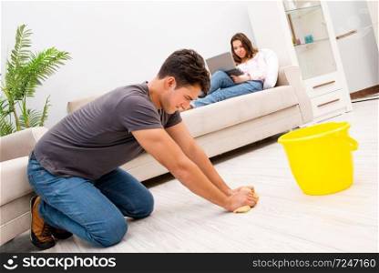 House floor cleaning concept with wife and husband. Young family doing cleaning at home