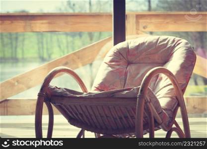 House furniture. Comfortable armchair with blanket on it in daylight with window in background. Comfortable armchair with window in background