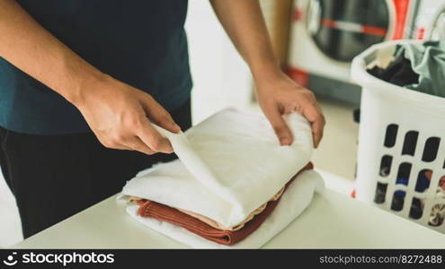 House husband with Basket and dirty laundry washed clothing in laundry room interior. washing machine at laundry business store concept