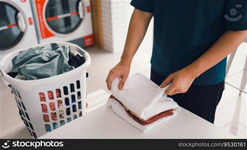 House husband with Basket and dirty laundry washed clothing in laundry room interior. washing machine at laundry business store concept