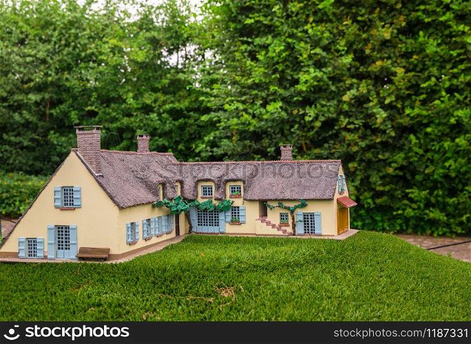 House in green forest, miniature scene outdoor, europe. Mini figures with high detaling of objects, realistically diorama