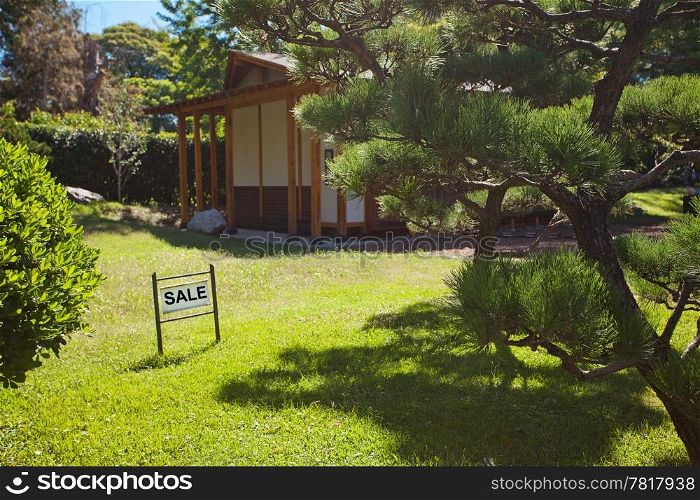 house in Japanese style on background of trees and card sale