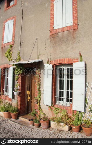 House in Provencal style with wooden shutters and a plastered facade