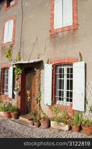 House in Provencal style with wooden shutters and a plastered facade