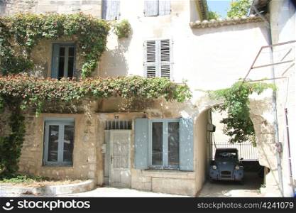 House in Provencal style with wooden shutters and a plastered facade