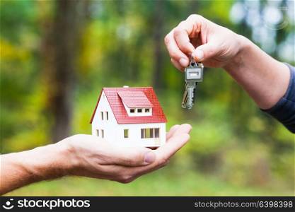 House model and key transfer. The concept of a loan for the purchase of housing. Home loan for you