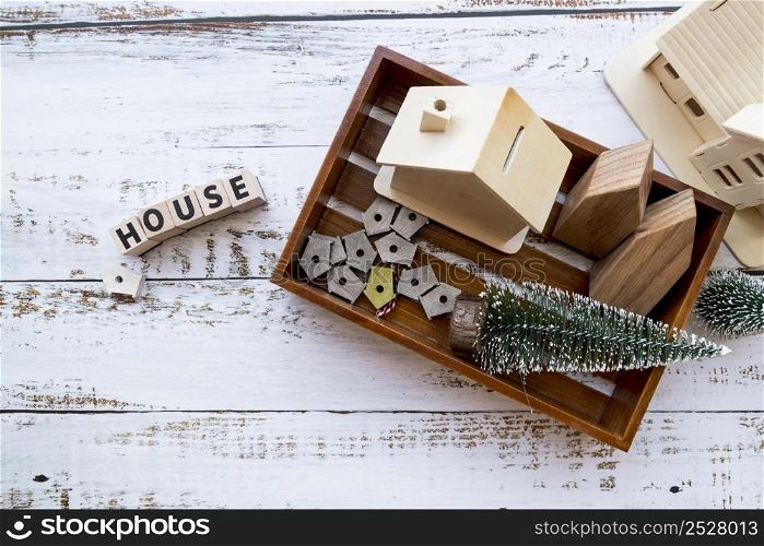 house model bird houses christmas tree wooden tray with text white textured backdrop