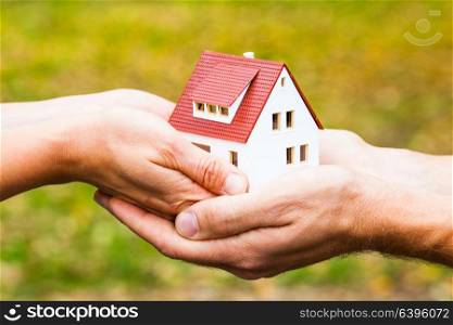 House model in the hands. The concept of a loan for the purchase of housing. Dreaming for own dwelling. Home for you