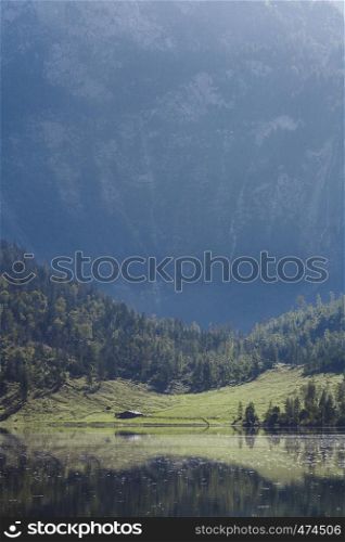 House near a German lake among the mountains at sunset with reflect over lake
