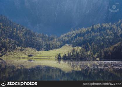 House near a German lake among the mountains at sunset with reflect over lake
