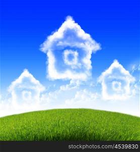 House of clouds in the blue sky against a background of green grass.