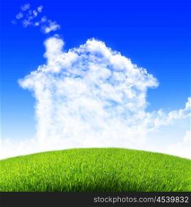 House of clouds in the blue sky against a background of green grass.