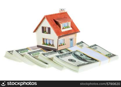 house on packs of banknotes isolated on white background
