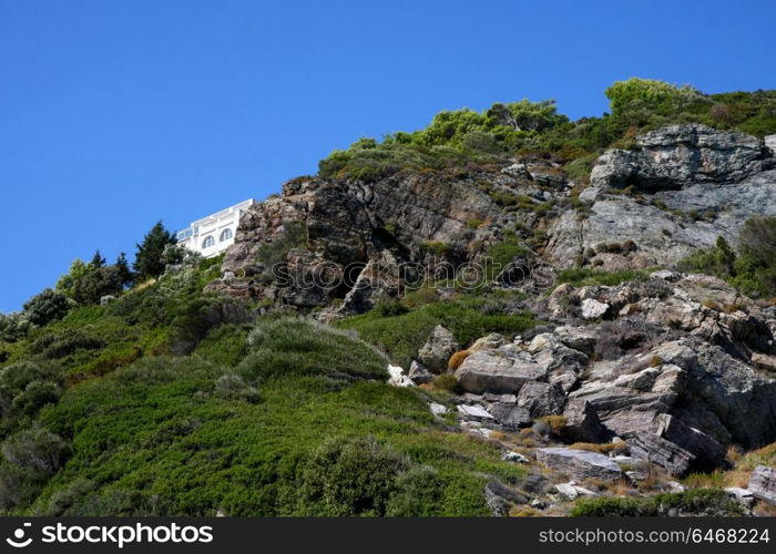 House on the rocks on the coast of Greek island Skopelos