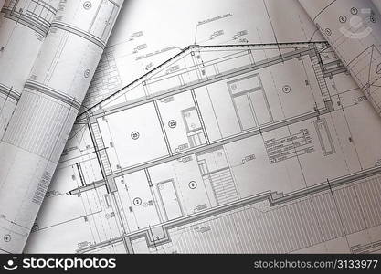 House plan blueprints roled up over table