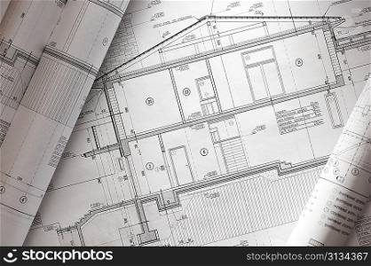 House plan blueprints roled up over table