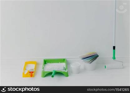 House renovation and accessories against white background. Set of paint tools with color samples. Painting and decoration concept
