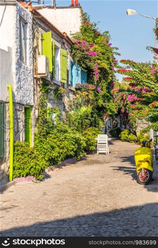 House with bougainvillaea and yellow scooter, Alacati, Izmir, Turkey