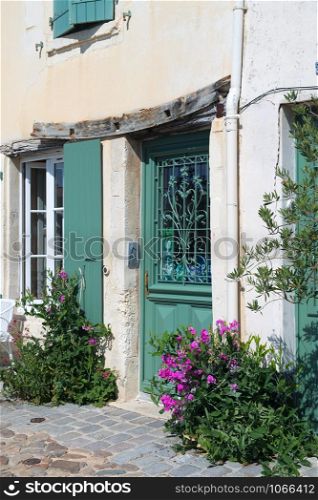 House with green shutters on French island Ile de Re
