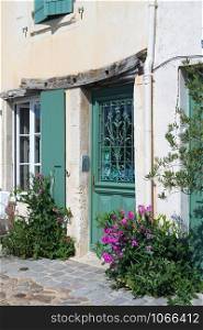 House with green shutters on French island Ile de Re