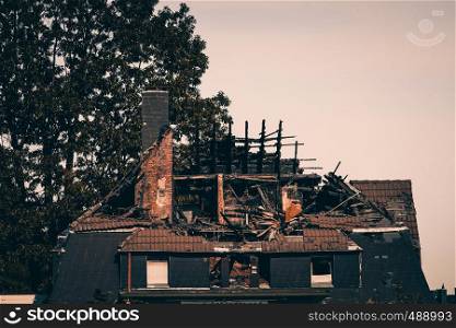 house with roof and top floor destroyed by fire