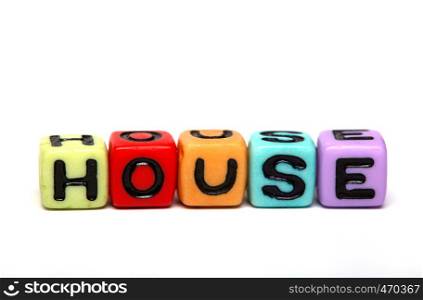 house - word made from multicolored child toy cubes with letters
