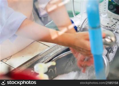 House Work, Close up image of washing dishes.
