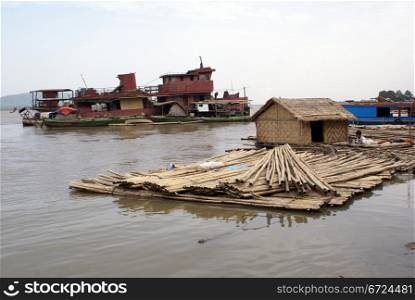 Houseboat and red ship on the river in Mandalay, Myanmar