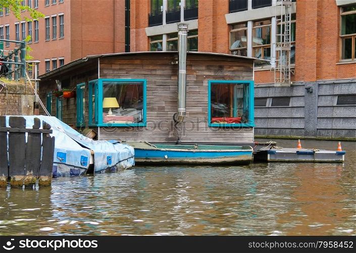 Houseboat on the waterfront canal in Amsterdam