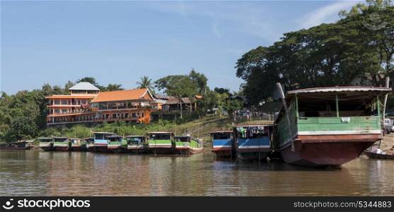 Houseboats along shoreline of River Mekong, Laos