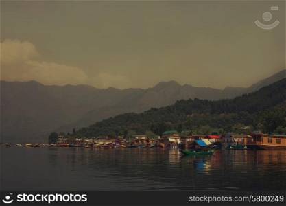 Houseboats on the lake in Srinagar against the mountains. India