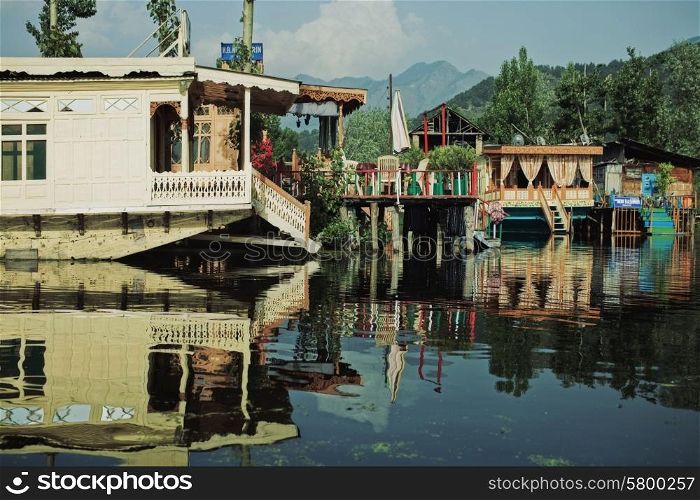 Houseboats on the lake in Srinagar against the mountains. India