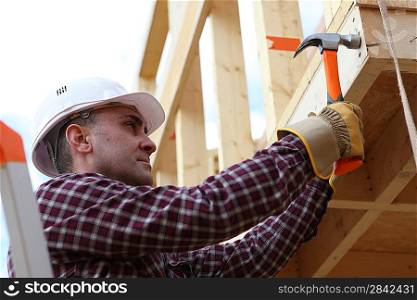Housebuilder using a hammer
