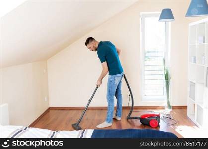 household, housework and cleaning concept - happy man with vacuum cleaner at home. man with vacuum cleaner at home. man with vacuum cleaner at home