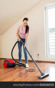 household, housework and cleaning concept - happy woman or housewife with vacuum cleaner at home. woman or housewife with vacuum cleaner at home. woman or housewife with vacuum cleaner at home