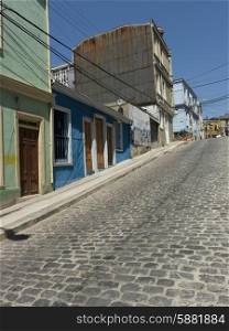 Houses along a cobblestone sloped street, Valparaiso, Chile