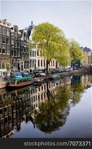 Houses along Singel canal historic waterfront, city of Amsterdam in spring, Holland.
