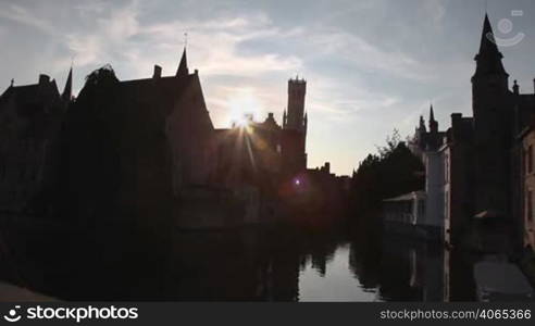 Houses and channel in Bruges, Belgium during sunset. Timelapse