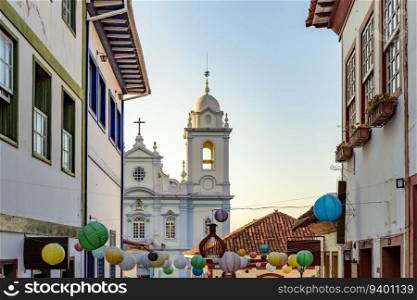 Houses and church in the streets of the city of Diamantina decorated with colorful lanterns and light fixtures. Houses and church in the streets of Diamantina